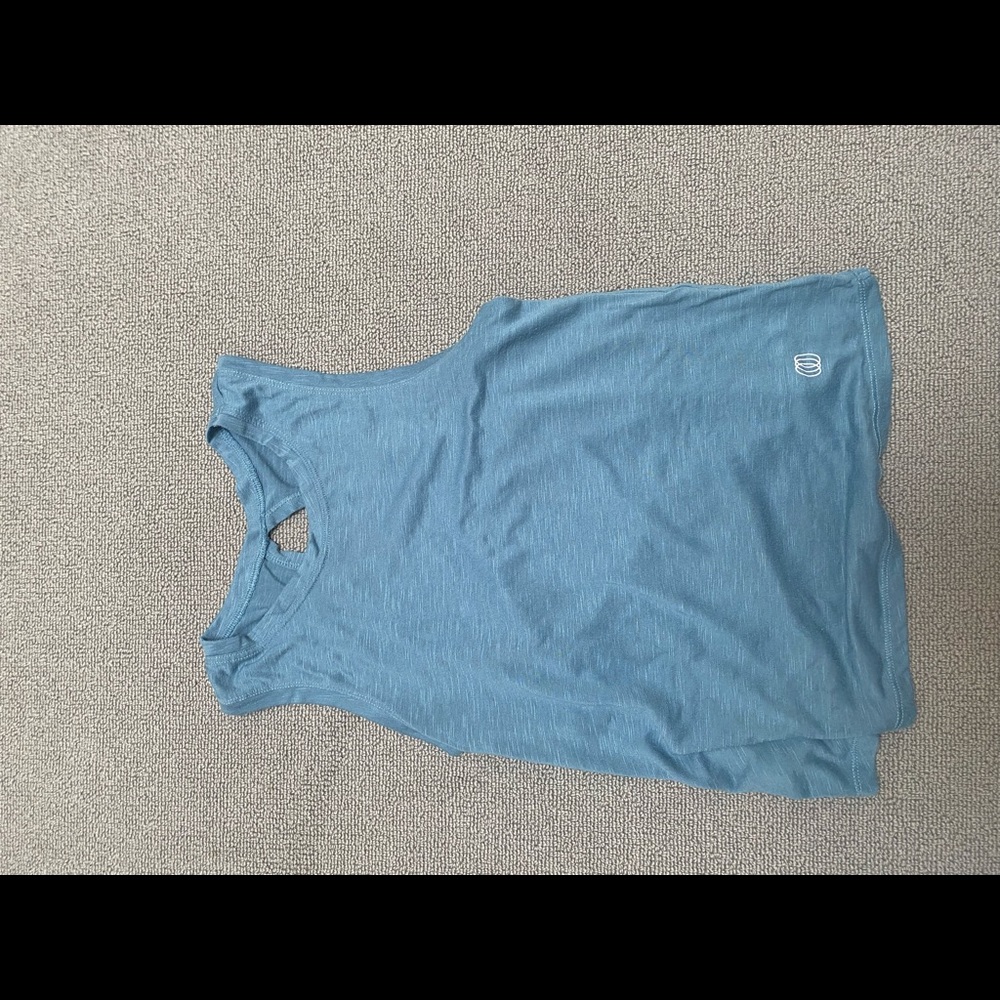 Blue tank top, very soft and loosely fit. There a cross back